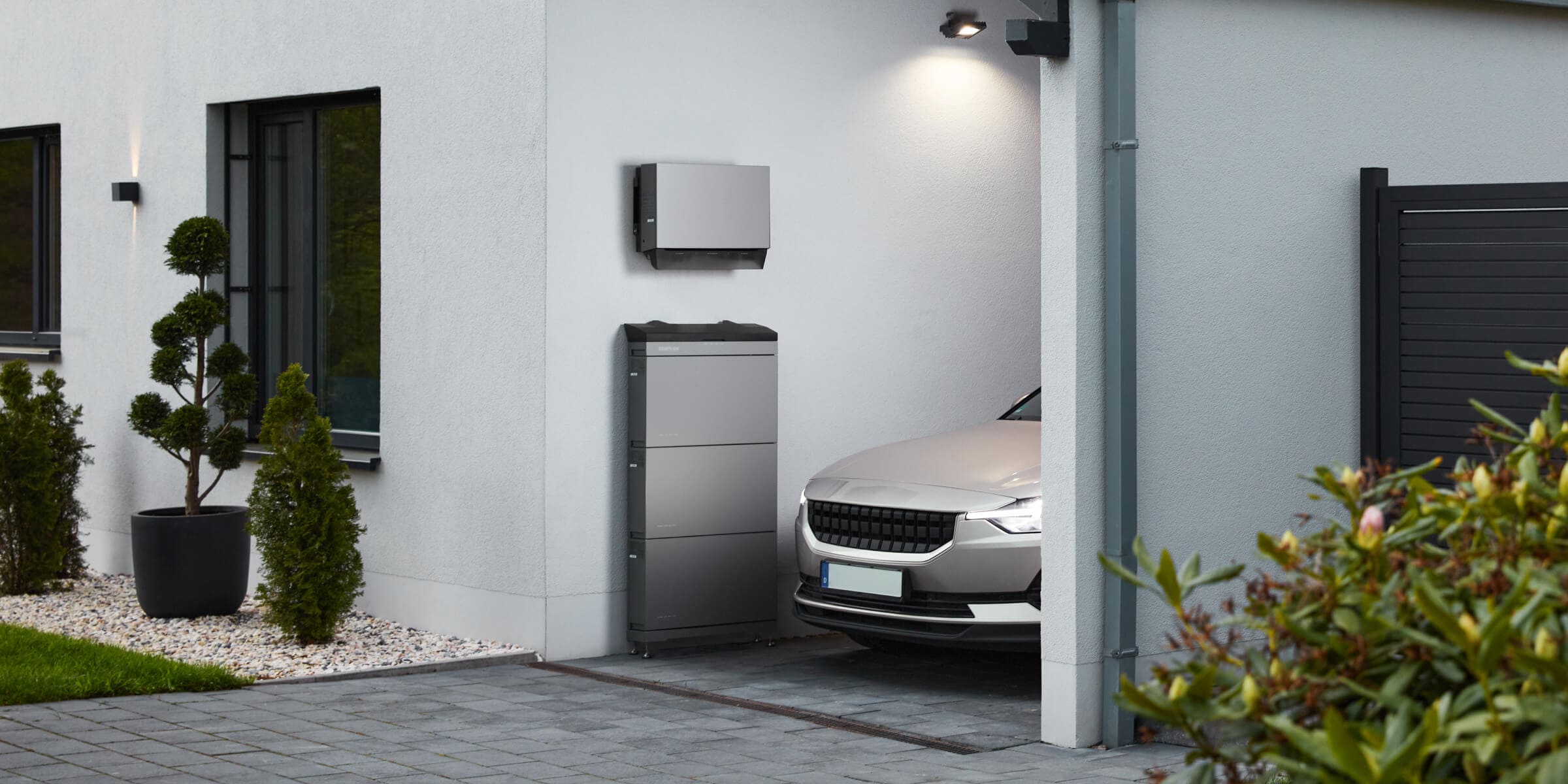 Home battery storage installed in a semi-covered car garage
