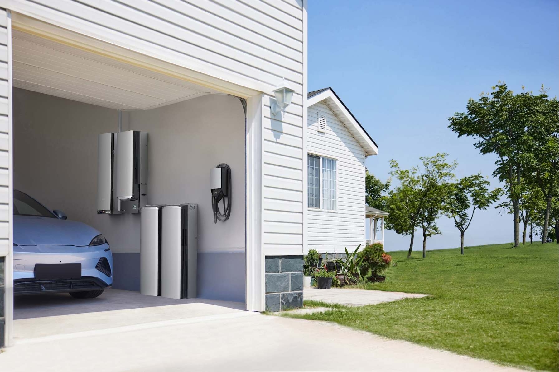 EcoFlow OCEAN Pro solar battery system and OCEAN EV Charger installed in home garage with electric vehicle charging on a sunny day