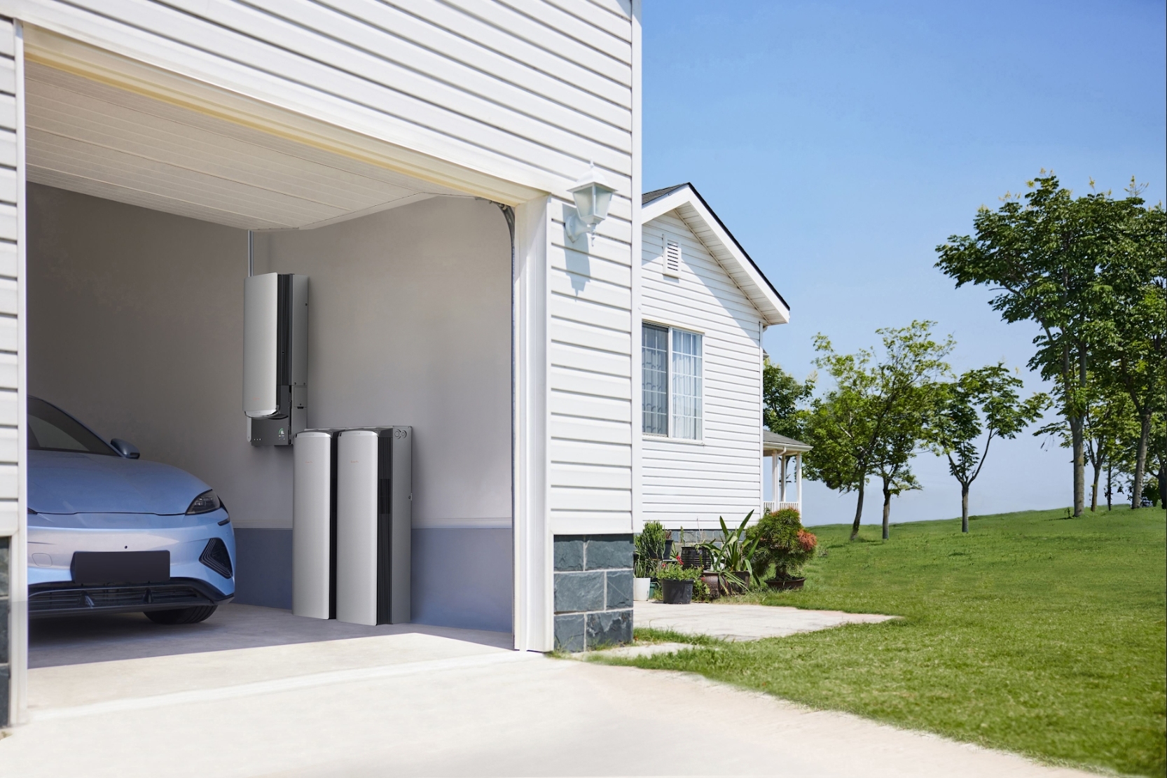 EcoFlow home battery system installed in a garage next to a blue electric car.
