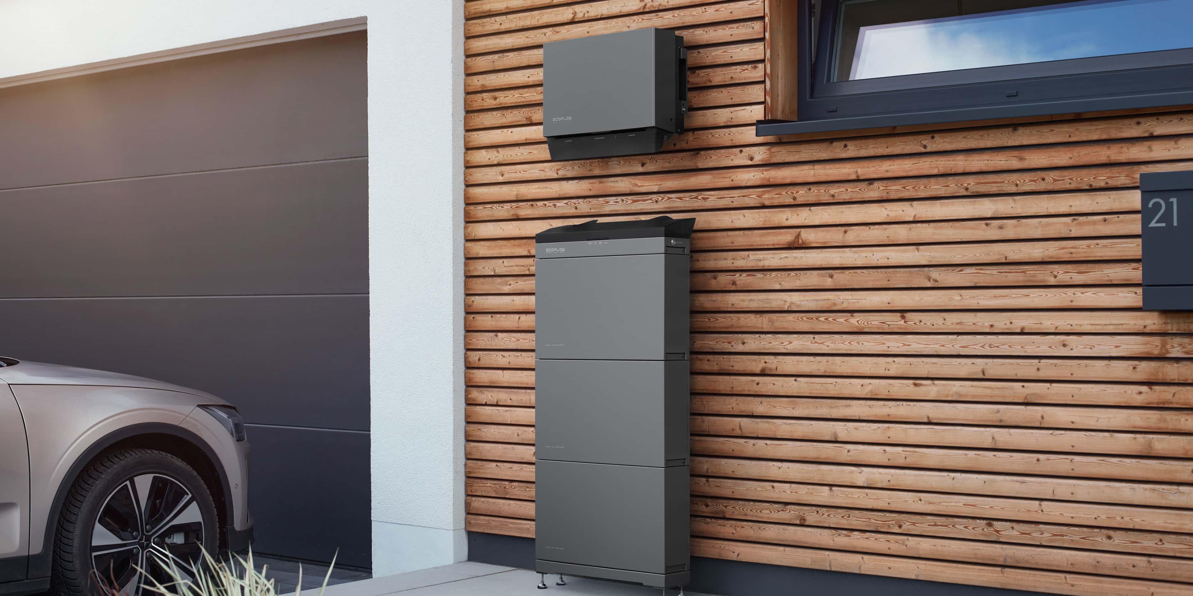 EcoFlow battery energy storage system for home installed on an exterior wall next to an EV