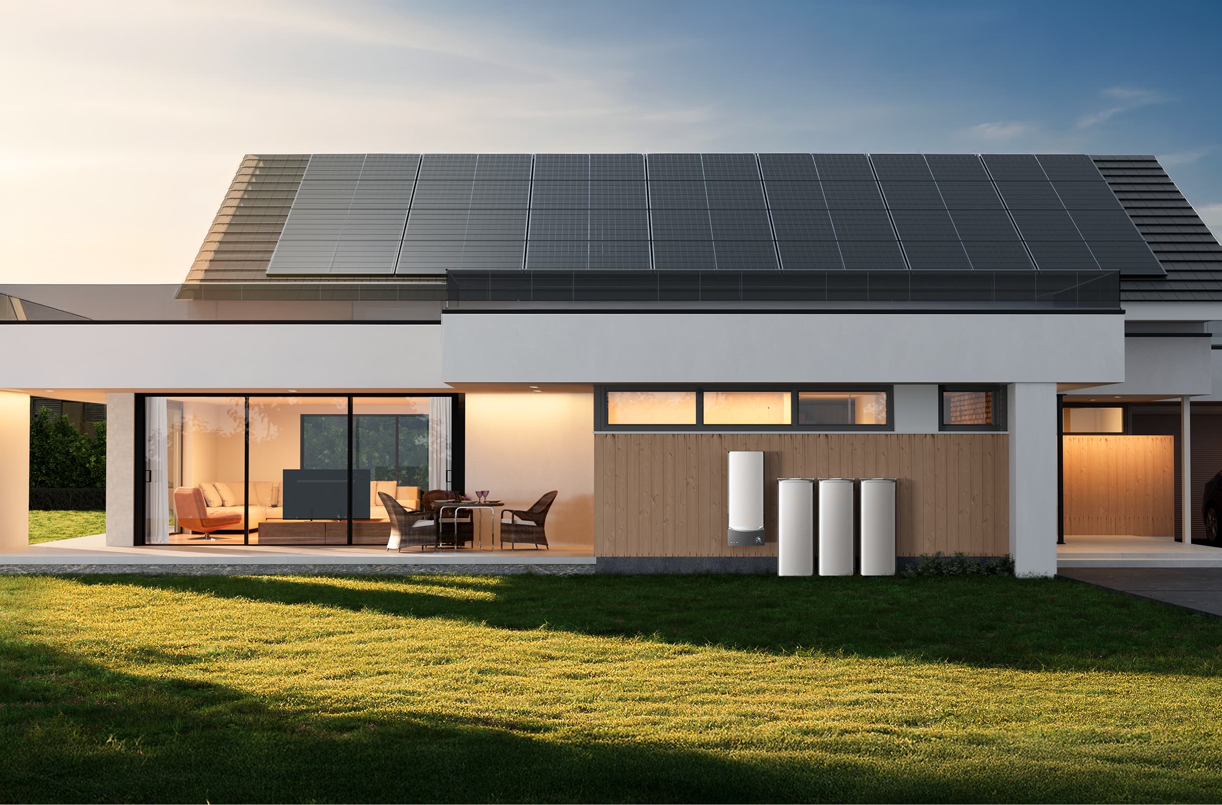 A modern home at sunset with solar panels on its roof and three white home battery units installed against a wooden exterior wall.