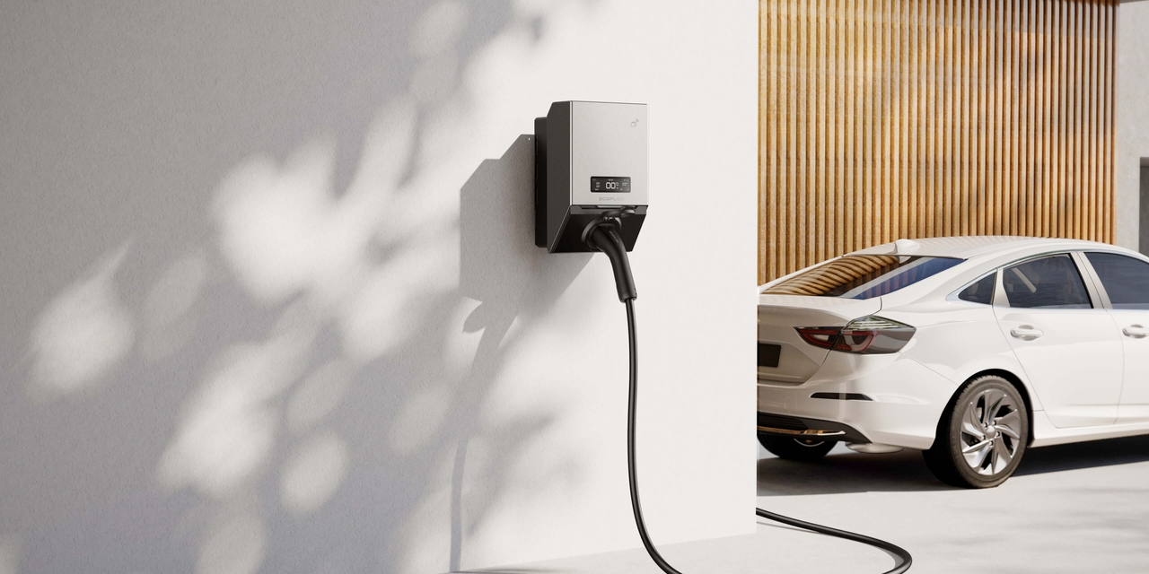 Modern electric vehicle charging beside UK home integrated with solar panels and EcoFlow Power Pulse 2