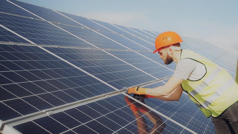 A professional installer installing solar energy