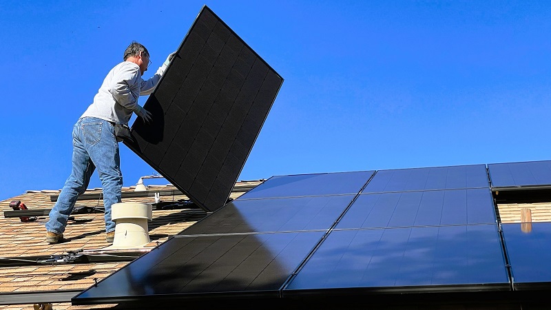 Professional installers installing solar panels on lease